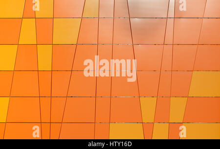 Geometric orange background from the tiles with different shapes. Stock Photo
