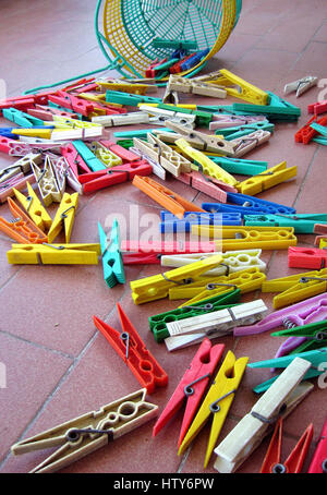 bunch of colorful plastic clothespins scattered Stock Photo
