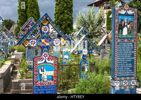 Romania, The Merry Cemetery (Cimitirul Vesel), in Sapanta, Maramures - famous for its colourful tombstones with naïve paintings describing. Stock Photo