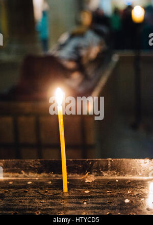 Pilgrims light candles in Crucifixion altar in the Church of the Holy Sepulchre, Jerusalem, Israel Stock Photo