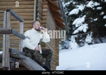 man sitting on veranda drinking a cup of tea Stock Photo