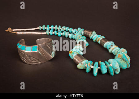 Antique Native American Sterling Silver Hollow-Form Cuff Bracelet with Overlay and Turquoise Inlay, and Large Turquoise Nugget and Silver Necklace. Stock Photo