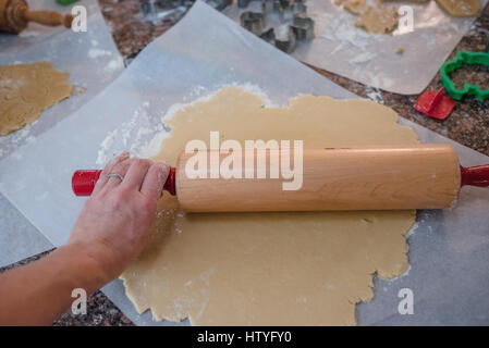 Woman rolling out dough for Christmas cookies Stock Photo