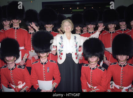 Dame Vera Lynn singing with the troops at a London recording studio, where she recorded new versions of the wartime favourite 'We'll Meet Again' and 'White Cliffs of Dover' with members of the 2nd Battalion Grenadier Guards as a backing choir. Stock Photo