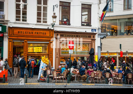 BRUSSELS, BELGIUM - MARCH 15: People enjoying traditional belgium fries at one of many belgian frites restaurants in Brussels, March 15, 2015 Stock Photo