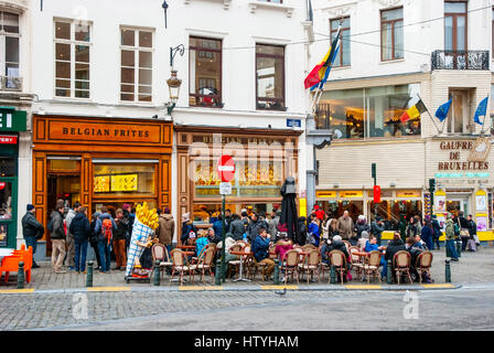 BRUSSELS, BELGIUM - MARCH 15: People enjoying traditional belgium fries at one of many belgian frites restaurants in Brussels, March 15, 2015 Stock Photo