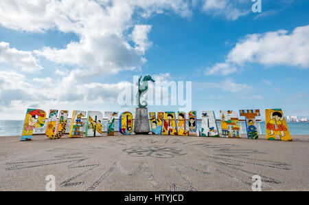 The colorful Puerto Vallarta sign on the Malecon with “Caballero del Mar” The Seahorse sculpture by Rafael Zamarripa, 1976, in the middle of the words Stock Photo