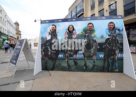 Locals put their faces on the bodies of jockeys in the Cheltenham Town Centre Stock Photo