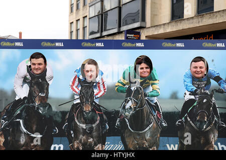 Locals put their faces on the bodies of jockeys in the Cheltenham Town Centre Stock Photo