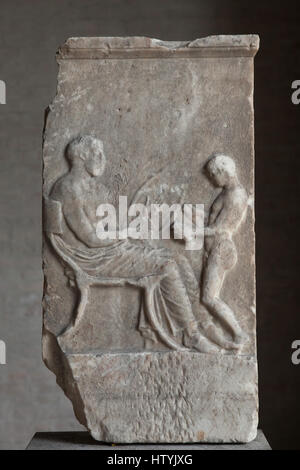 Lyre player. Funerary relief from Magna Graecia (South Italy) from about 420 BC on display in the Glyptothek Museum in Munich, Bavaria, Germany. A young boy is depicted reading from a scroll and reciting a poem on the melody of the lyre. Stock Photo