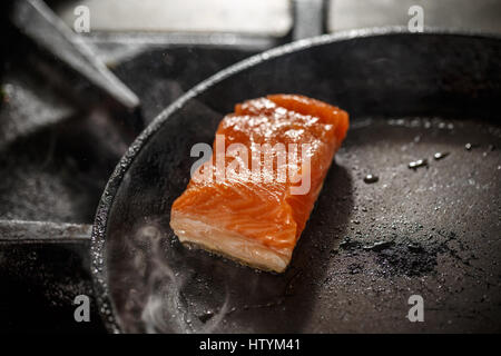 Frying fresh salmon steak on the pan Stock Photo