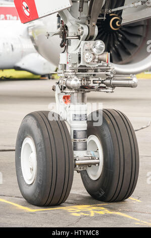 Closeup section of an Airbus A350 nose wheel undercarriage on the taxiway at an aviation trade event in Farnborough, UK Stock Photo