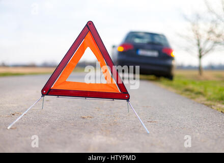 breakdown triangle stands near a broken car Stock Photo