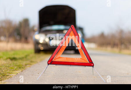 breakdown triangle stands near a broken car Stock Photo