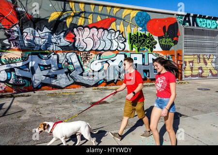 Florida South,Miami,Wynwood,urban graffiti,street art artwork,painted wall mural,adult adults man men male,woman women female lady,couple,young adult, Stock Photo