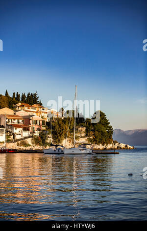 View on the Albanian shore and mountains over the sea and bay in Kassiopi, Corfu, Greece. Incredible clouds on blue sky, colorful sea. Stock Photo
