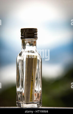 Message in the bottle. A letter in a vial found on the waves of Atlantic. Stock Photo