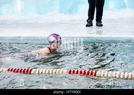 SAHYURTA, IRKUTSK REGION, RUSSIA - March 11.2017: Cup of Baikal. Winter Swimming Competitions. Woman swims Stock Photo