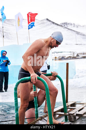 SAHYURTA, IRKUTSK REGION, RUSSIA - March 11.2017: Cup of Baikal. Winter Swimming Competitions. Swimmer after finish. Stock Photo