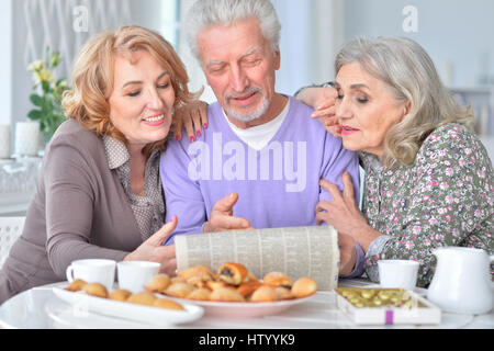 Elderly people having breakfast and reading a newspaper Stock Photo