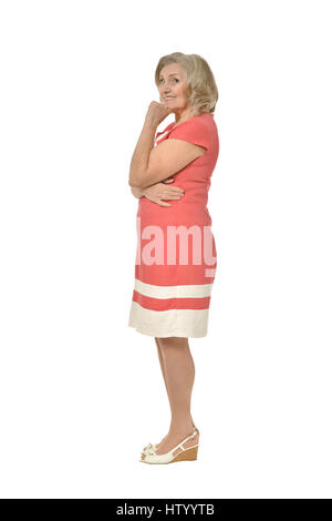 senior woman in coral dress Stock Photo