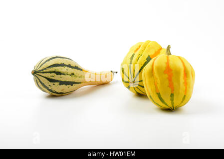 three small striped pumpkins on white background Stock Photo