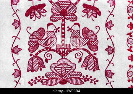 Folk embroidery red thread on white linen canvas. Traditional Ukrainian embroidery motifs Stock Photo