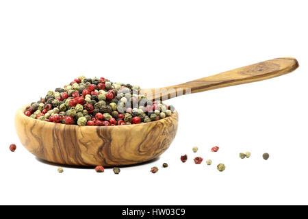 mixed peppercorns in a bowl made of olive wood  isolated on white background Stock Photo