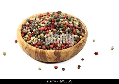 mixed peppercorns in a bowl made of olive wood  isolated on white background Stock Photo