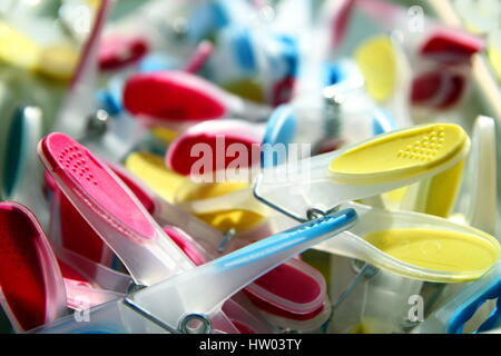 Closeup of brightly coloured clothes pegs with selective focus Stock Photo
