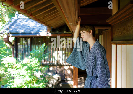 Caucasian man wearing yukata in traditional Japanese house Stock Photo