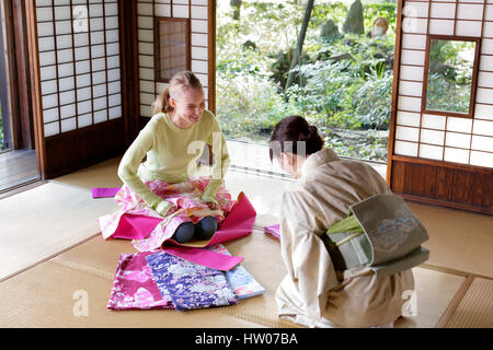 Caucasian woman wearing yukata at traditional Japanese house Stock Photo