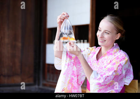 Caucasian woman wearing yukata in traditional Japanese house Stock Photo