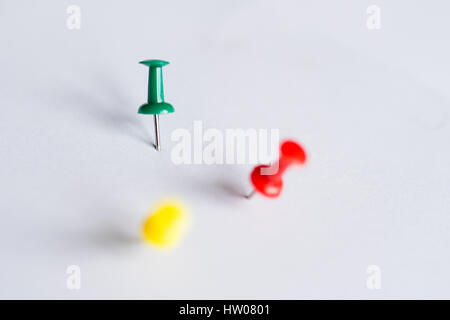 Set of push pins in different colors, with real shadows, isolated on white background. (Selective Focus) Stock Photo