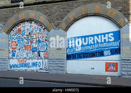 Bristol, UK. 15th March, 2017. New street art in the Stokes Croft area of the city highlights opposition to possible changes to the National Health Service. The artwork appears alongside previous pieces publicising the national demonstration against the changes which was held in London on 4th March, 2017. Keith Ramsey/Alamy Live News Stock Photo