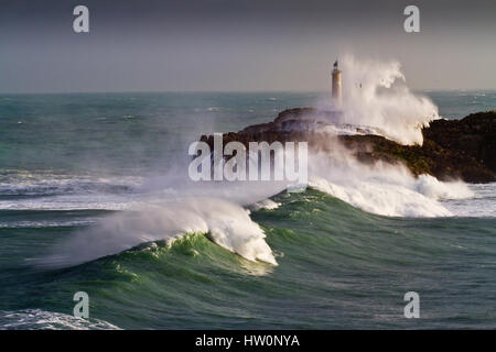 Mouro island and lighthouse in a storm.  Santander. Cantabria, Spain. Stock Photo