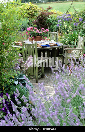 Outdoor furniture in courtyard garden. Stock Photo