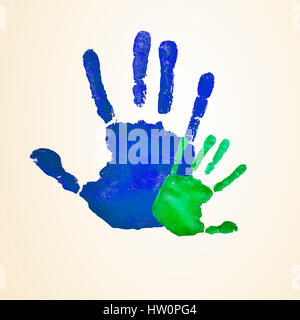a blue handprint of an adult and a green infant handprint, depicting the idea of family, or the relationship of a father or mother and his or her son  Stock Photo