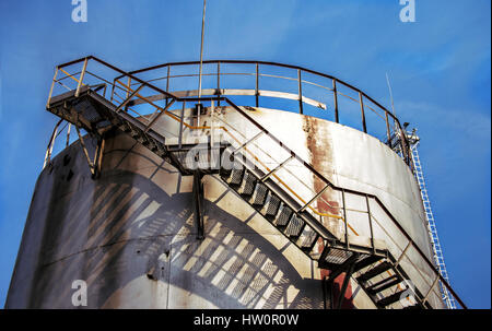 Large oil tank in industrial plant at twilight Stock Photo