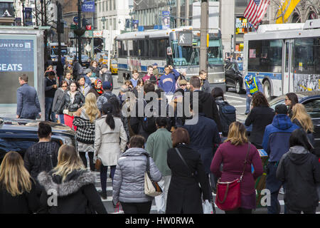 People at the always crowded intersection of 5th Avenue and 42nd Street in New York City, Stock Photo