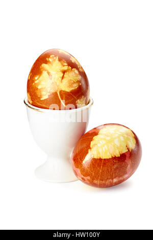 Two colorful decorated easter eggs and holder on white Stock Photo
