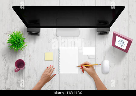 Woman write something on pad. Blank paper to add text, drawing, sketch. Computer display with blank screen beside. Blank business card and note paper  Stock Photo