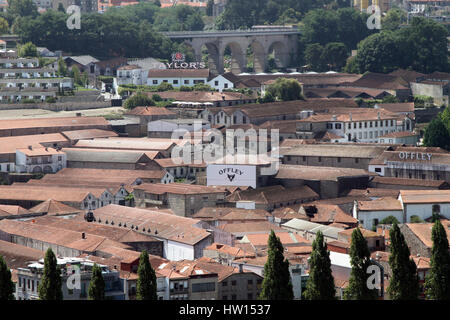 View over the port houses in Vila Nova de Gaia, which lies across the Douro river from the city of Porto. Stock Photo