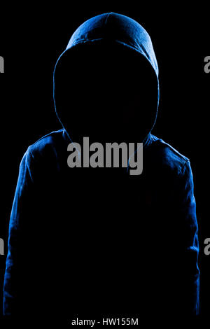 Anonymous user with hood in black background studio shot, faceless. Stock Photo