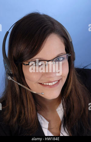 Young woman calls up a Headset, Junge Frau telefoniert mit einem Headset Stock Photo