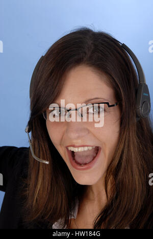 Young woman calls up a Headset, Junge Frau telefoniert mit einem Headset Stock Photo