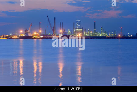 Industrial Petrochemical plant and sea in night time Stock Photo