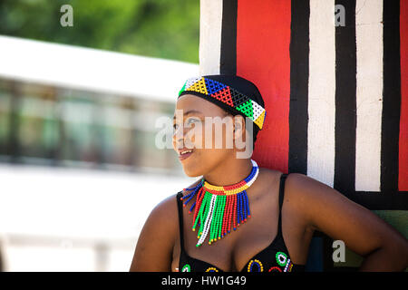 Lesedi Cultural Village, SOUTH AFRICA - 4 November 2016: Young Zulu woman in colourful traditional bead work costume. Stock Photo