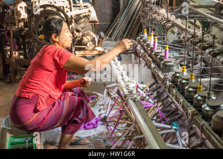 Silk Weaving Factory Worker near Amarapura, Myanmar Stock Photo