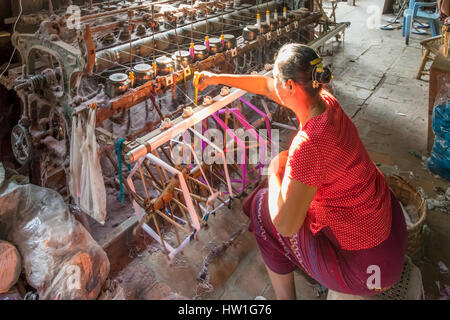 Silk Weaving Factory Worker near Amarapura, Myanmar Stock Photo